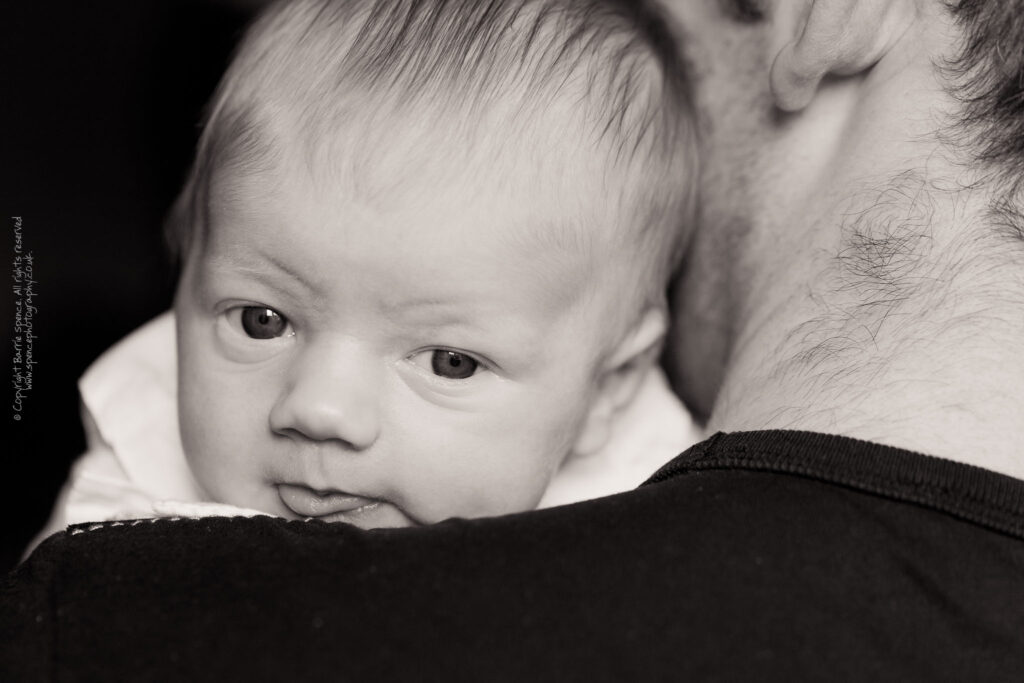 Baby Ruby looking over Scott's shoulder. Baby Ruby looking over Scott's shoulder (black & white) / © Copyright 2011 Barrie Spence. All rights reserved.